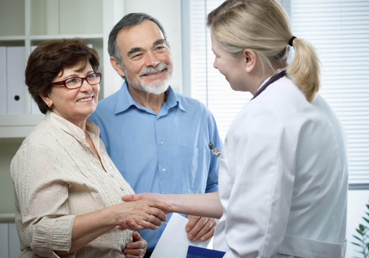 Hearing Aid Counseling and Fitting Couple Receiving Hearing Aid Counseling From An Audiologist During a Fitting